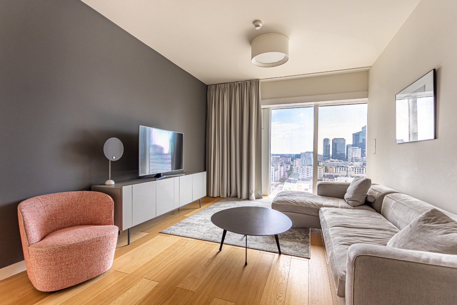 Living room of a 2-room apartment in Złota 44 with a panorama of Warsaw
